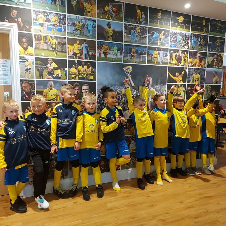 Young kids infront of players wall